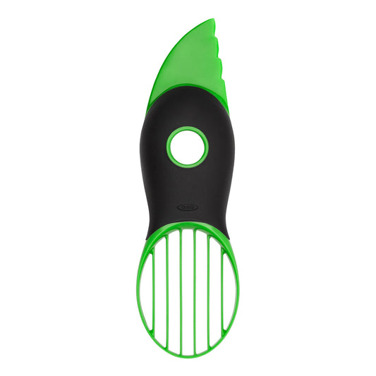 Green and black vegetable peeler on a white background
