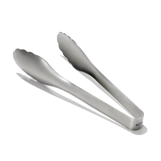 Metallic tongs on a white background